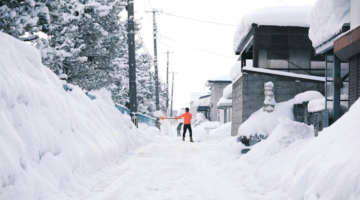 a person walking down a snow covered street