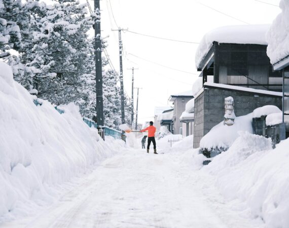 a person walking down a snow covered street